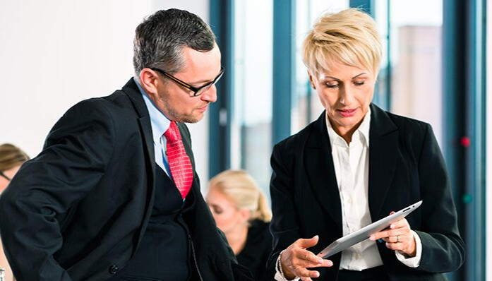 Two professionals reviewing documents, representing strategic GRE Verbal preparation.